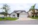 Two-story house with gray siding, white accents, and a three-car garage at 7465 Yale Harbor Dr, Wesley Chapel, FL 33545