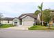 Two-story house with gray siding, white accents, and a two-car garage at 7465 Yale Harbor Dr, Wesley Chapel, FL 33545