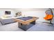 Game room with pool table, sectional sofa, and hanging chair at 7465 Yale Harbor Dr, Wesley Chapel, FL 33545