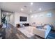 Spacious living room featuring a large sectional sofa and hardwood floors at 7465 Yale Harbor Dr, Wesley Chapel, FL 33545