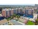 Aerial view of beachfront property with pool and tennis court at 1000 Gulf Blvd # 302, Indian Rocks Beach, FL 33785