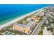 Aerial view of beachfront property, showing building, pool, tennis court, and beach at 1000 Gulf Blvd # 302, Indian Rocks Beach, FL 33785