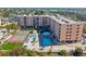 Aerial view showing building, pool, and tennis court at 1000 Gulf Blvd # 302, Indian Rocks Beach, FL 33785