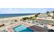 Aerial view of beach, pool, tennis court, and building at 1000 Gulf Blvd # 302, Indian Rocks Beach, FL 33785