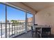 Balcony with table and chairs, overlooking beach and tennis court at 1000 Gulf Blvd # 302, Indian Rocks Beach, FL 33785