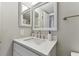 Bathroom with vanity, mirror and white cabinetry at 1000 Gulf Blvd # 302, Indian Rocks Beach, FL 33785
