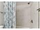 Bathroom with shower/tub combo, marble tile and coastal decor at 1000 Gulf Blvd # 302, Indian Rocks Beach, FL 33785