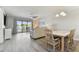 Combined living and dining area with light flooring and plenty of space at 1000 Gulf Blvd # 302, Indian Rocks Beach, FL 33785