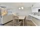Dining area with table and chairs, view into living room and kitchen at 1000 Gulf Blvd # 302, Indian Rocks Beach, FL 33785