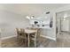 Bright dining area with light wood table and chairs, kitchen pass-through at 1000 Gulf Blvd # 302, Indian Rocks Beach, FL 33785