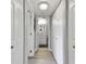 Hallway with light wood flooring, white doors and bathroom access at 1000 Gulf Blvd # 302, Indian Rocks Beach, FL 33785