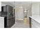 Black refrigerator and white kitchen cabinets at 1000 Gulf Blvd # 302, Indian Rocks Beach, FL 33785