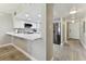 Open concept kitchen with white cabinets and a breakfast bar at 1000 Gulf Blvd # 302, Indian Rocks Beach, FL 33785