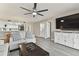 Living room with comfortable seating, a large TV, and access to the balcony at 1000 Gulf Blvd # 302, Indian Rocks Beach, FL 33785