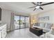 Bright living room with balcony access, comfy seating and ocean views at 1000 Gulf Blvd # 302, Indian Rocks Beach, FL 33785