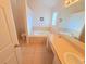 Bathroom featuring a soaking tub, and a neutral vanity with ample counter space and tile flooring at 10232 Oakhurst Rd, Largo, FL 33774