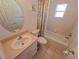 A classic bathroom with a vanity sink and tub, plus tiled floor and floral shower curtain at 10232 Oakhurst Rd, Largo, FL 33774