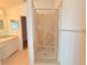 A bright bathroom featuring a shower with decorative glass and a vanity with a sink at 10232 Oakhurst Rd, Largo, FL 33774