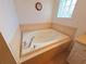 Close-up of a tiled-in bathtub with chrome fixtures and a small window for natural light at 10232 Oakhurst Rd, Largo, FL 33774