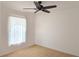Bedroom features window with lace curtains and a ceiling fan at 10232 Oakhurst Rd, Largo, FL 33774