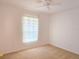 Bright bedroom with a ceiling fan and window dressed with sheer curtains at 10232 Oakhurst Rd, Largo, FL 33774