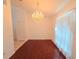 Dining room featuring hardwood floors, a chandelier, and a window with curtains at 10232 Oakhurst Rd, Largo, FL 33774