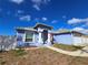 Charming, single-story blue house with a well-manicured lawn and a 'House for Sale' sign at 10232 Oakhurst Rd, Largo, FL 33774