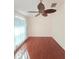 Bright living room featuring hardwood floors and a decorative ceiling fan, enhancing the home's cozy ambiance at 10232 Oakhurst Rd, Largo, FL 33774