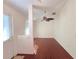 Bright living room with hardwood floors, a ceiling fan, and a view of the front door at 10232 Oakhurst Rd, Largo, FL 33774