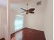 Bright living room featuring hardwood floors and a decorative ceiling fan, enhancing the home's cozy ambiance at 10232 Oakhurst Rd, Largo, FL 33774