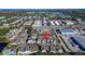 Aerial view displays community proximity to retail businesses, roads, and a swimming pool at 1050 Starkey Rd # 704, Largo, FL 33771