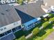 A sunny aerial shot displays a fenced backyard, lanai, and well-kept landscaping at 1050 Starkey Rd # 704, Largo, FL 33771
