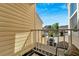 Balcony with a railing, wooden floor, a small carpet, and a neighborhood view under a blue sky at 1050 Starkey Rd # 704, Largo, FL 33771