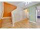 Open entryway with hardwood floors, stairs, and multiple doorways leading to various rooms at 1050 Starkey Rd # 704, Largo, FL 33771
