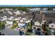 Street view of townhomes with attached garages and mature palm trees in a well-maintained community at 1050 Starkey Rd # 704, Largo, FL 33771