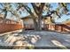 Backyard with large tree, wooden deck, and concrete patio at 1100 E Louisiana Ave, Tampa, FL 33603