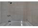 Bathroom with a shower/tub combo and tile surround at 1100 E Louisiana Ave, Tampa, FL 33603