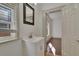 Small bathroom with pedestal sink and mirror at 1100 E Louisiana Ave, Tampa, FL 33603