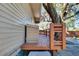 Wooden deck with storage space and a view of a large oak tree at 1100 E Louisiana Ave, Tampa, FL 33603