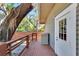 Wooden deck next to house with storage and large tree at 1100 E Louisiana Ave, Tampa, FL 33603