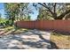 Driveway with wooden gate and access to backyard at 1100 E Louisiana Ave, Tampa, FL 33603