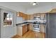 Kitchen with wood cabinets, stainless steel appliances, and hardwood floors at 1100 E Louisiana Ave, Tampa, FL 33603