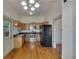 Kitchen with wood cabinets, stainless steel appliances, and hardwood floors at 1100 E Louisiana Ave, Tampa, FL 33603