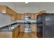 Kitchen with wood cabinets, stainless steel appliances, and hardwood floors at 1100 E Louisiana Ave, Tampa, FL 33603