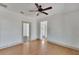 Spacious living room featuring hardwood floors and a ceiling fan at 1100 E Louisiana Ave, Tampa, FL 33603