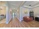 Hallway with wood-look floors and access to rooms at 13230 Fawn Lily Dr, Riverview, FL 33579