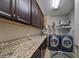 Laundry room with granite countertop and washer/dryer at 13230 Fawn Lily Dr, Riverview, FL 33579