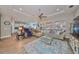 Open living room with hardwood floors and ample natural light, view of kitchen at 13230 Fawn Lily Dr, Riverview, FL 33579
