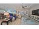 Open living room with hardwood floors and ample natural light, view of kitchen at 13230 Fawn Lily Dr, Riverview, FL 33579