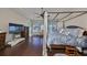 Main bedroom with canopy bed, hardwood floors, and plenty of natural light at 13230 Fawn Lily Dr, Riverview, FL 33579